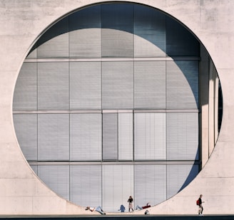 people walking on a sidewalk in front of a building