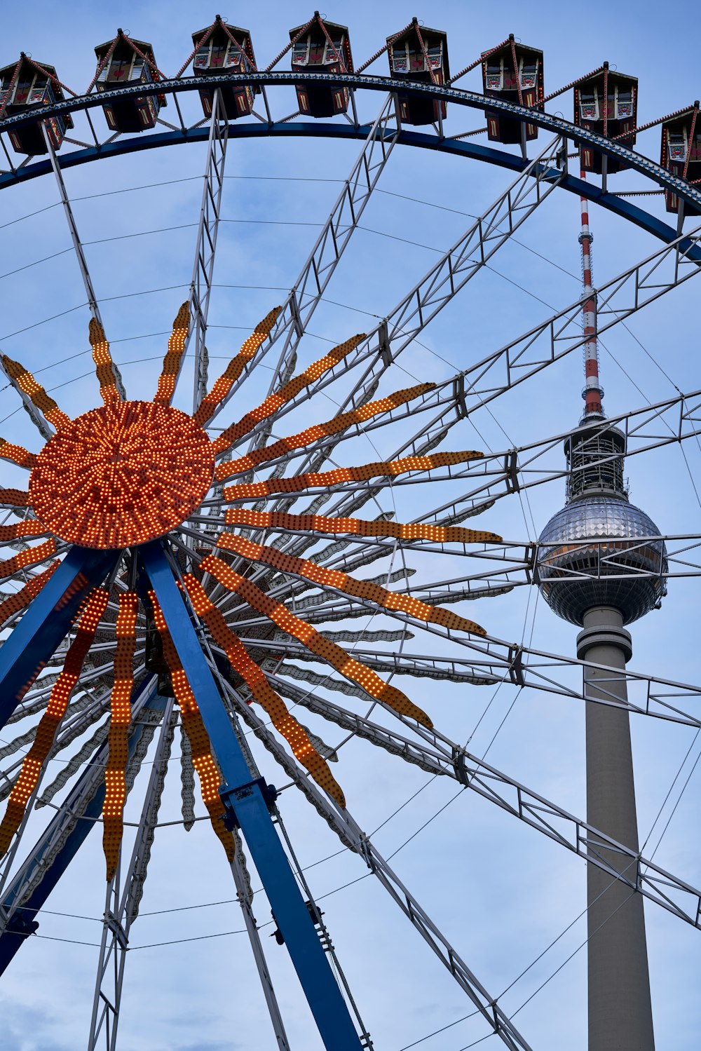 a ferris wheel with a tower in the background