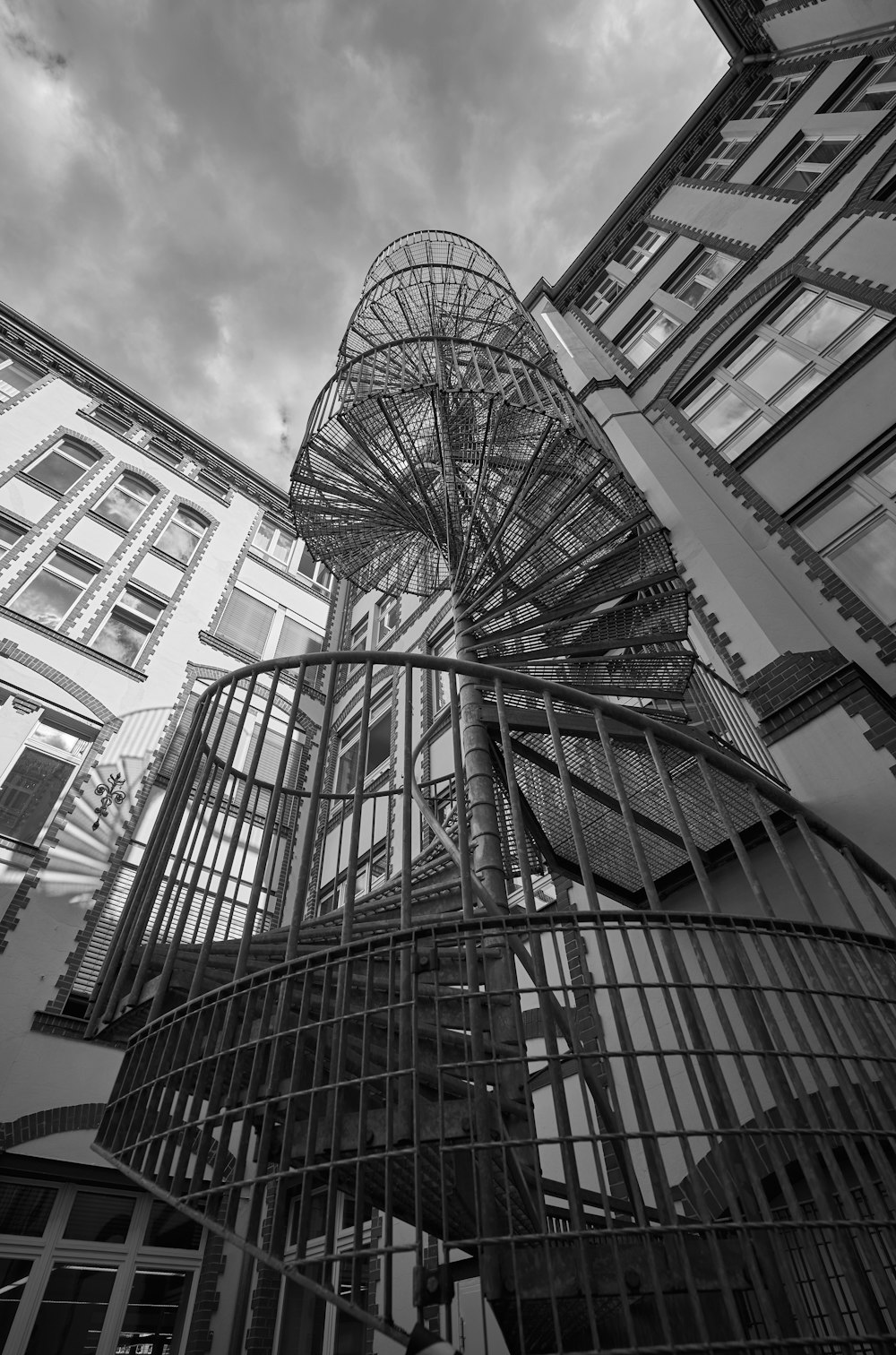 a black and white photo of a spiral staircase