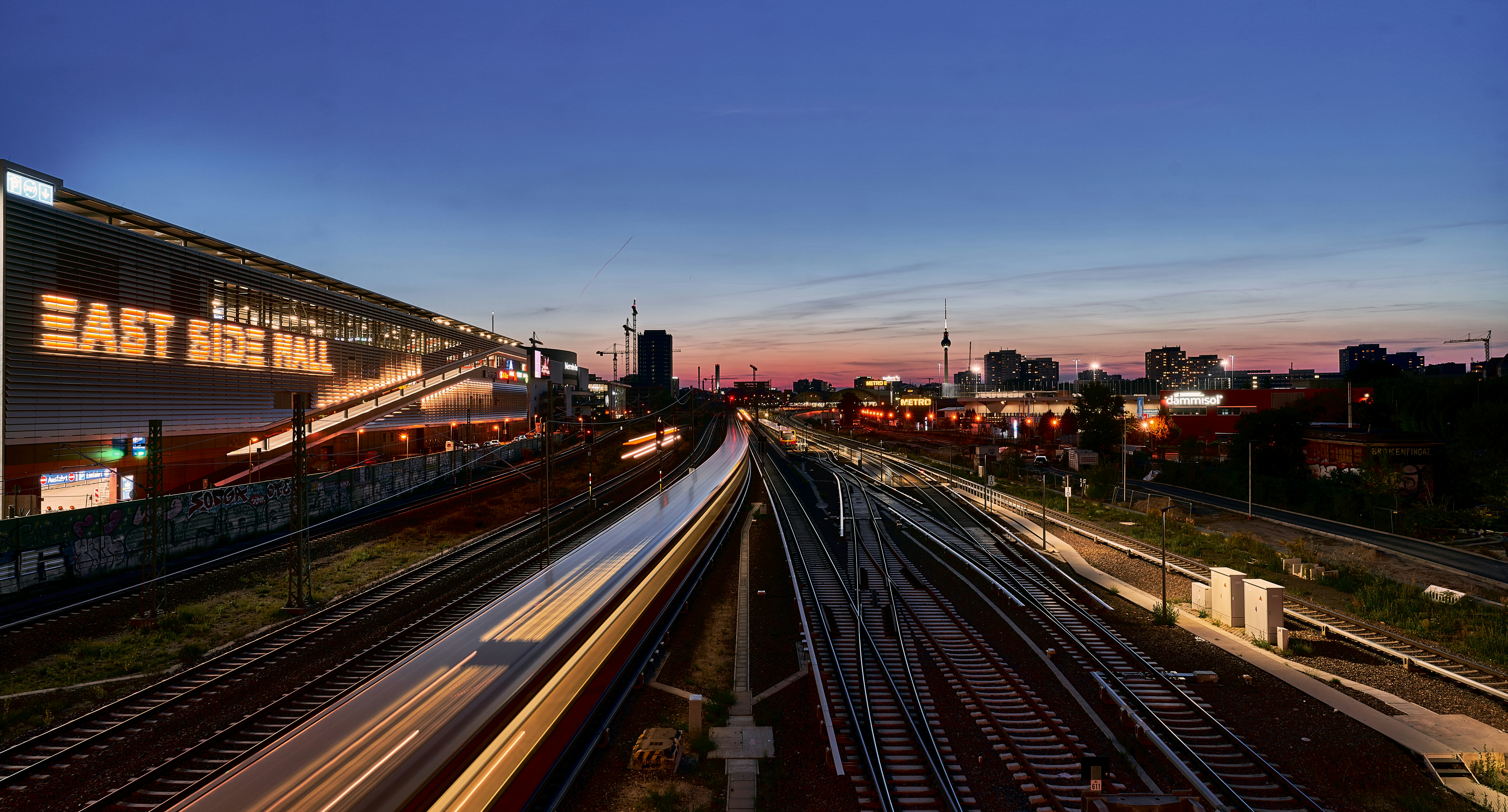 a train station with a train on the tracks, 