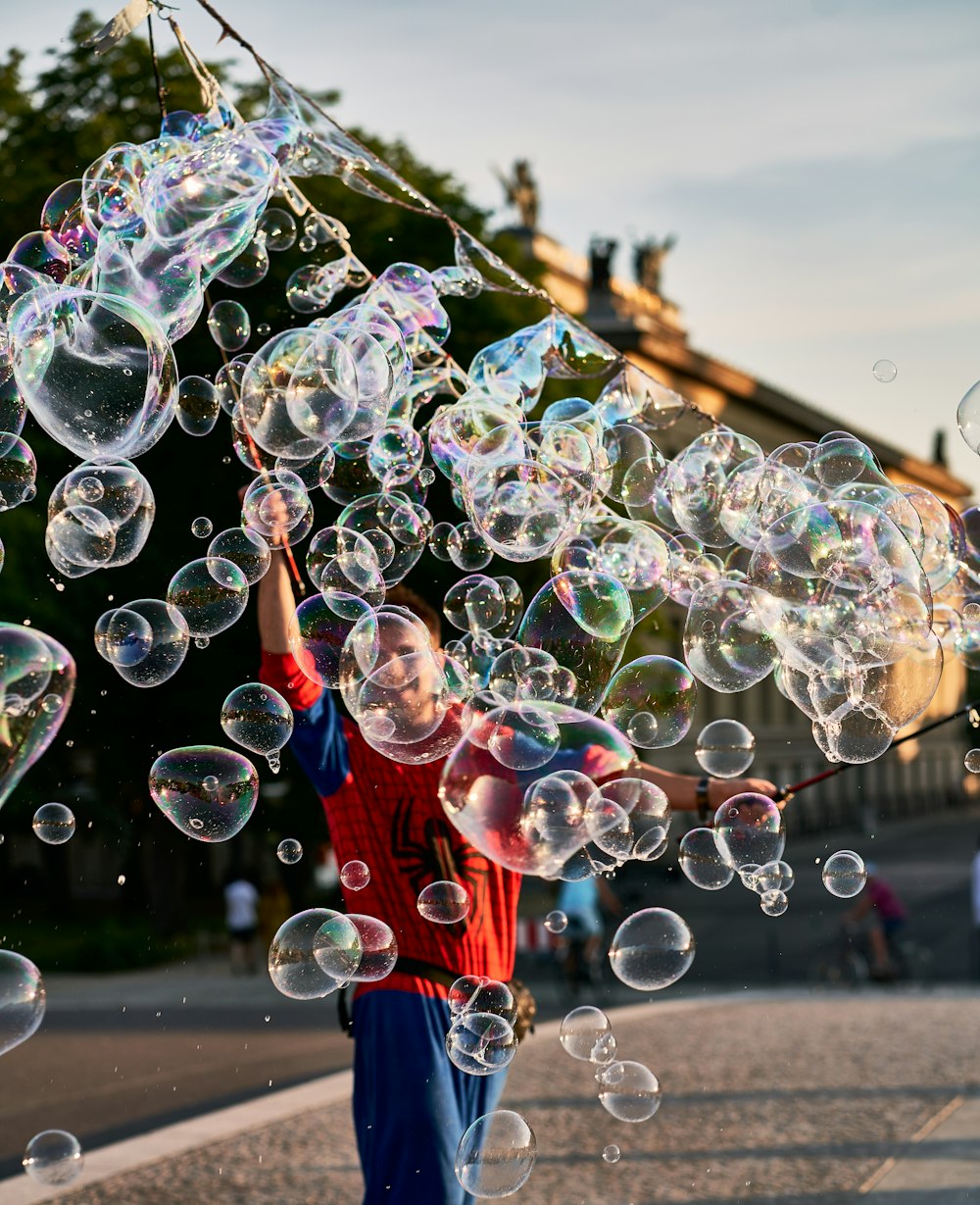 a young boy is playing with soap bubbles