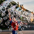 a young boy is playing with soap bubbles