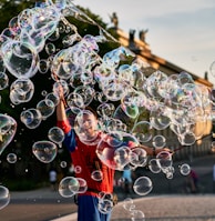 a young boy is playing with soap bubbles