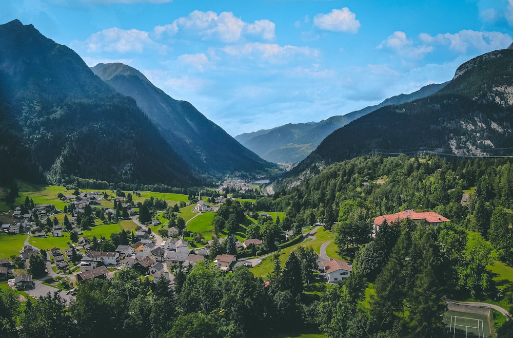 a scenic view of a village surrounded by mountains