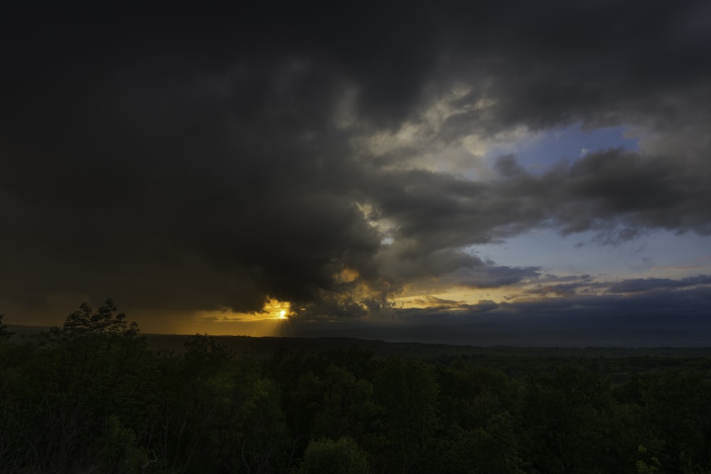 the sun is shining through the dark clouds