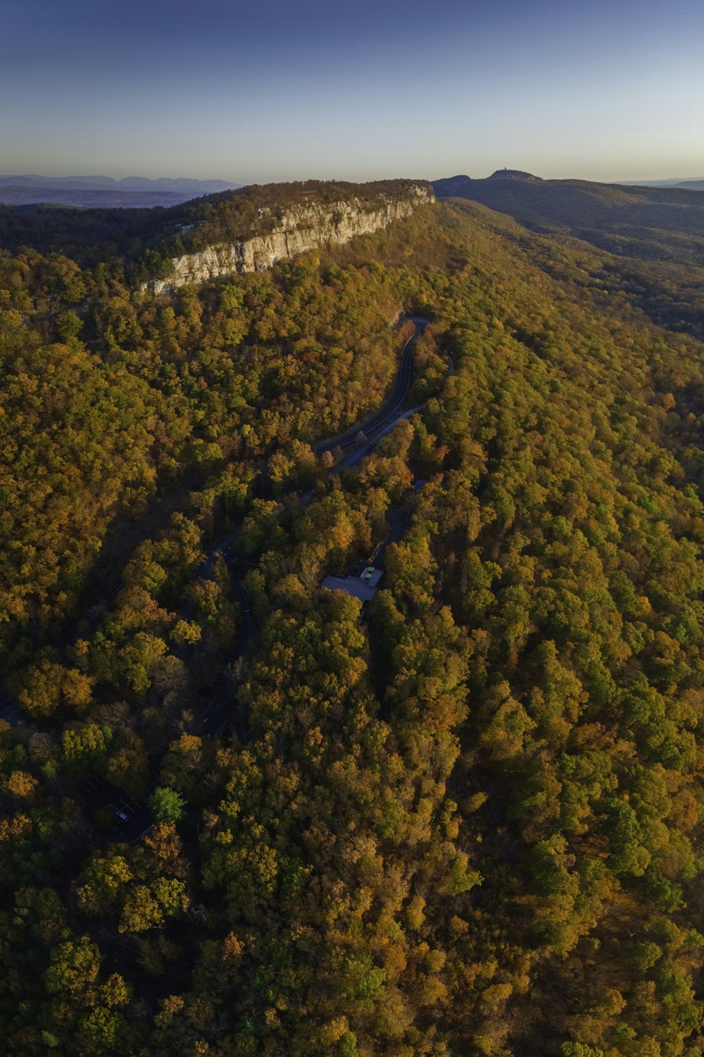 an aerial view of a forested area with a river running through it