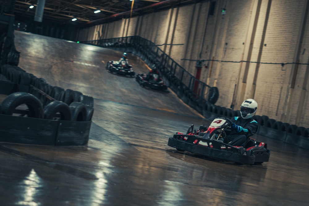 a group of people riding go karts in a race track