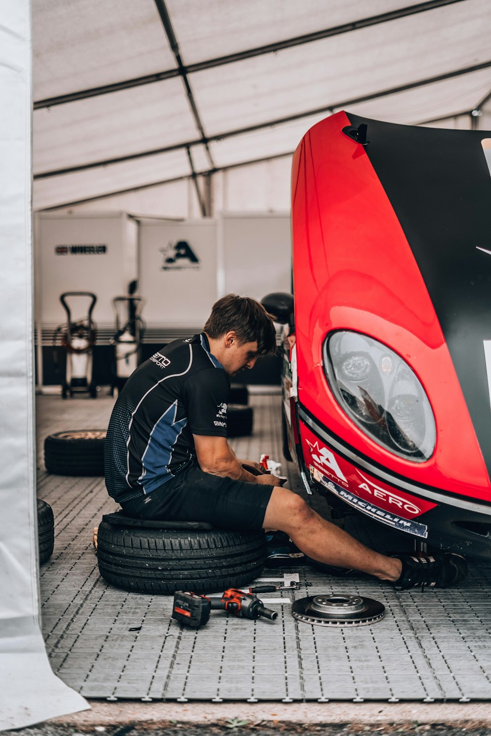 a man working on a car in a garage