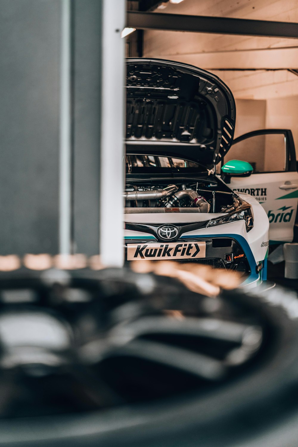 a car with its hood open in a garage