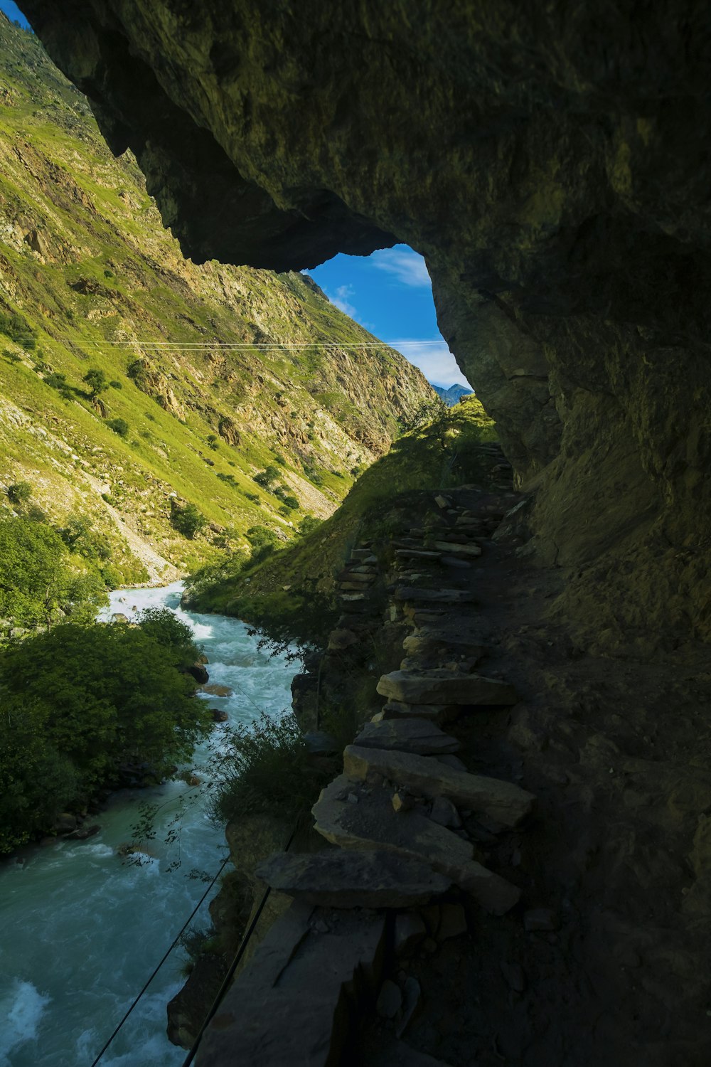 a river running through a lush green valley