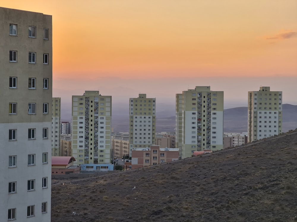 a group of tall buildings sitting on top of a hill