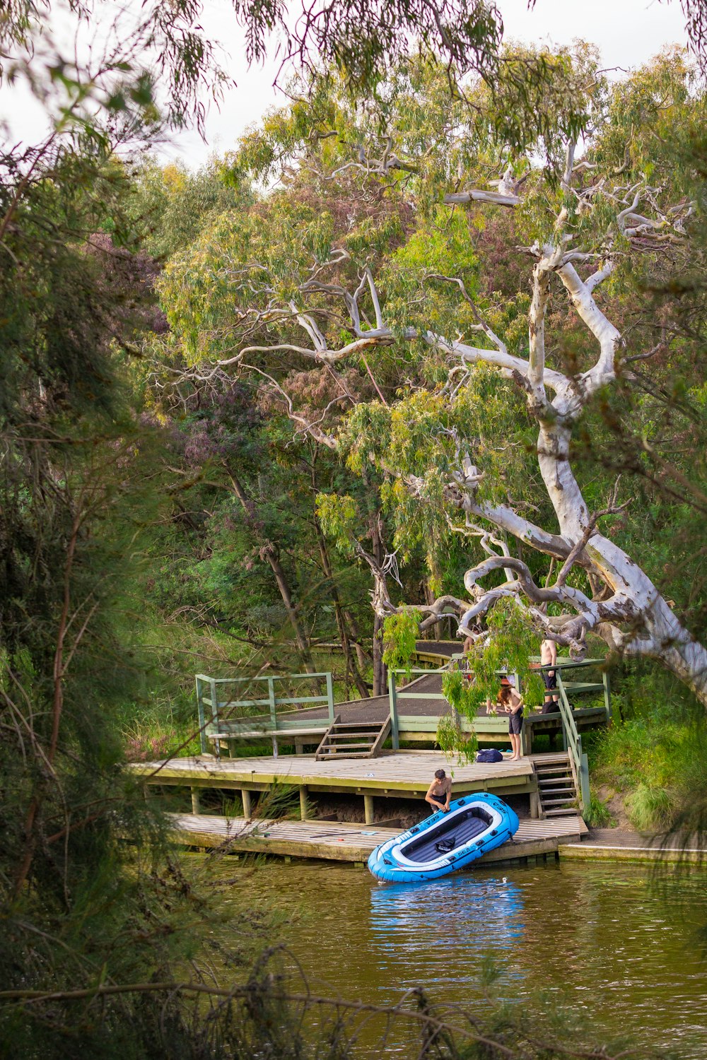 a blue boat floating on top of a body of water