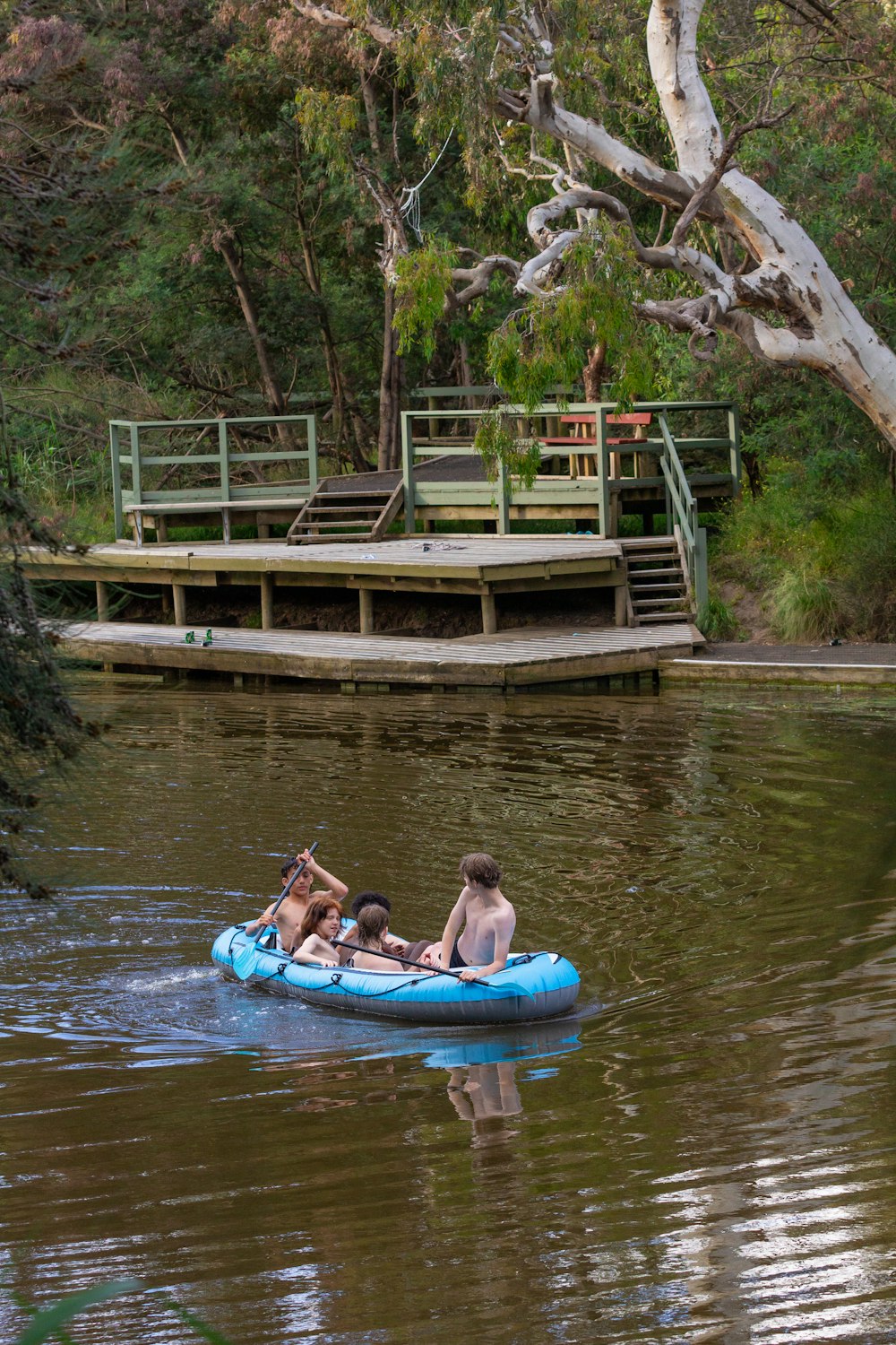 a group of people riding on top of a raft down a river