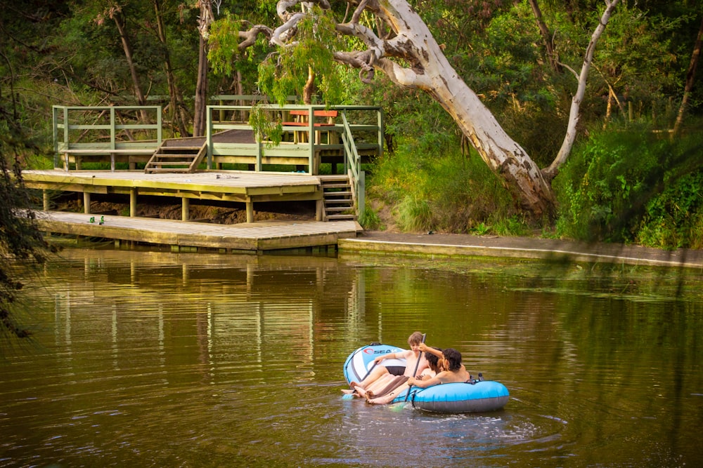 a couple of people floating on top of a body of water