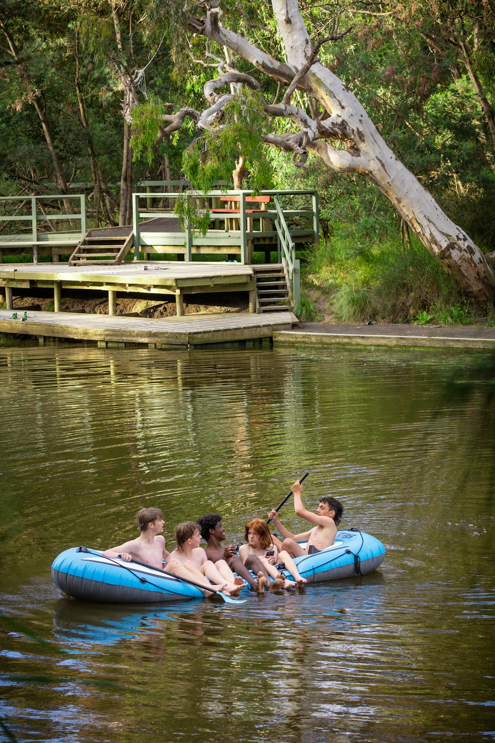 a group of people floating on top of a body of water