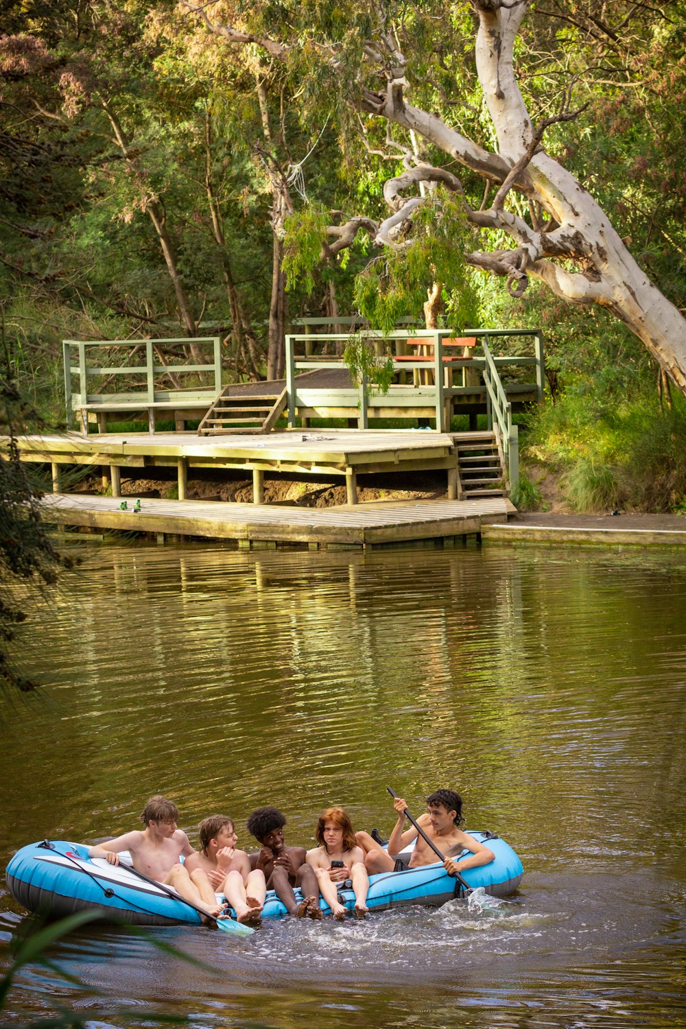 a group of people floating on top of a body of water