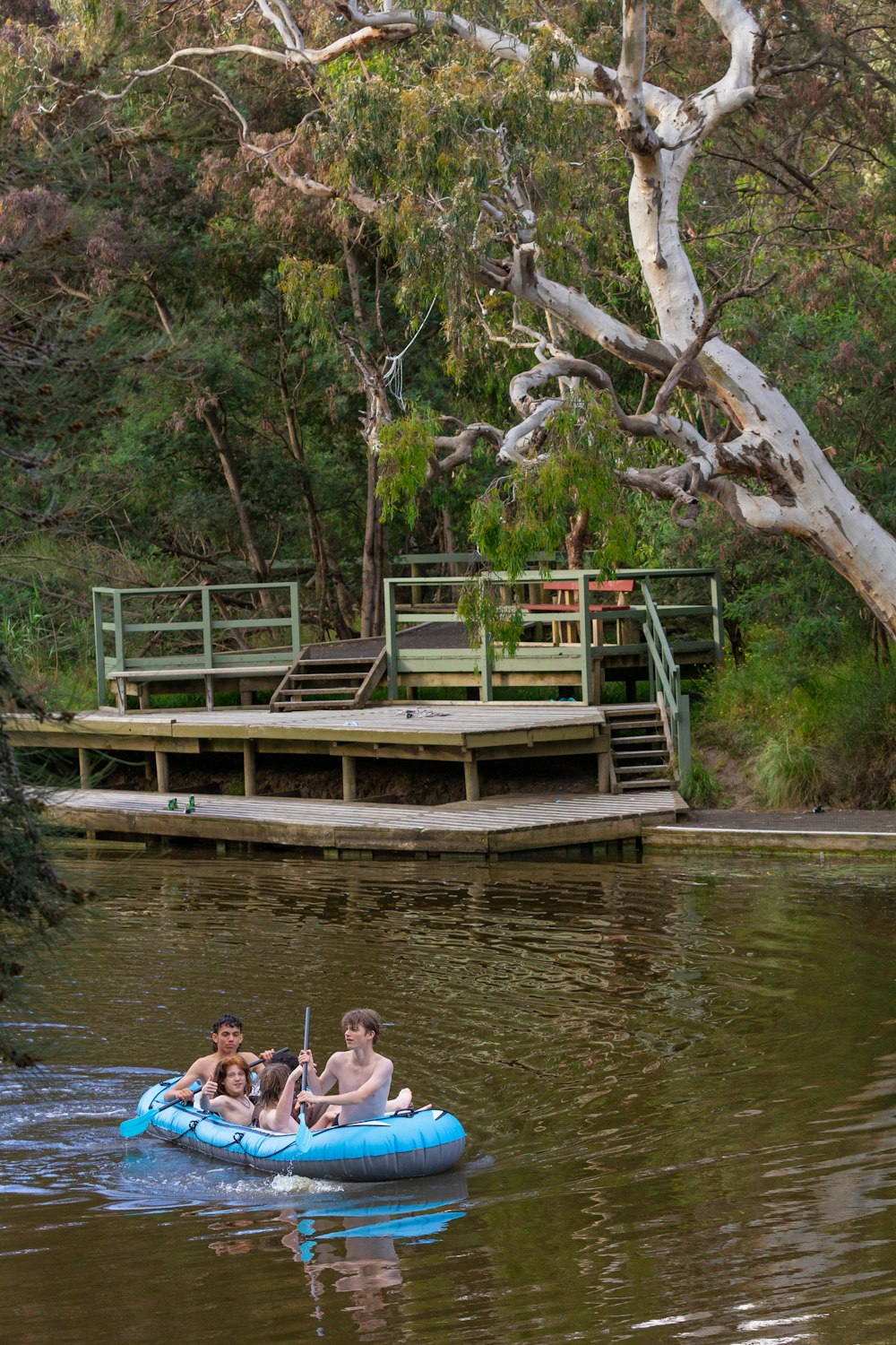 Eine Gruppe von Menschen fährt in einem Floß einen Fluss hinunter