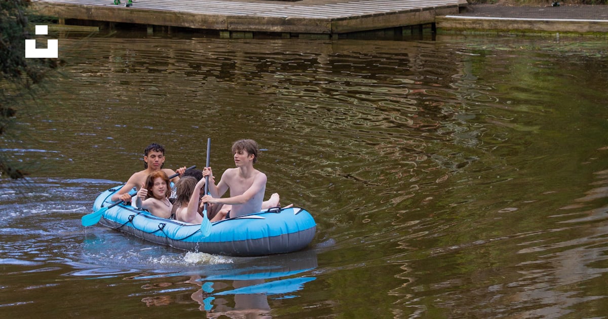 A group of people riding in a raft down a river photo – Free Splash ...