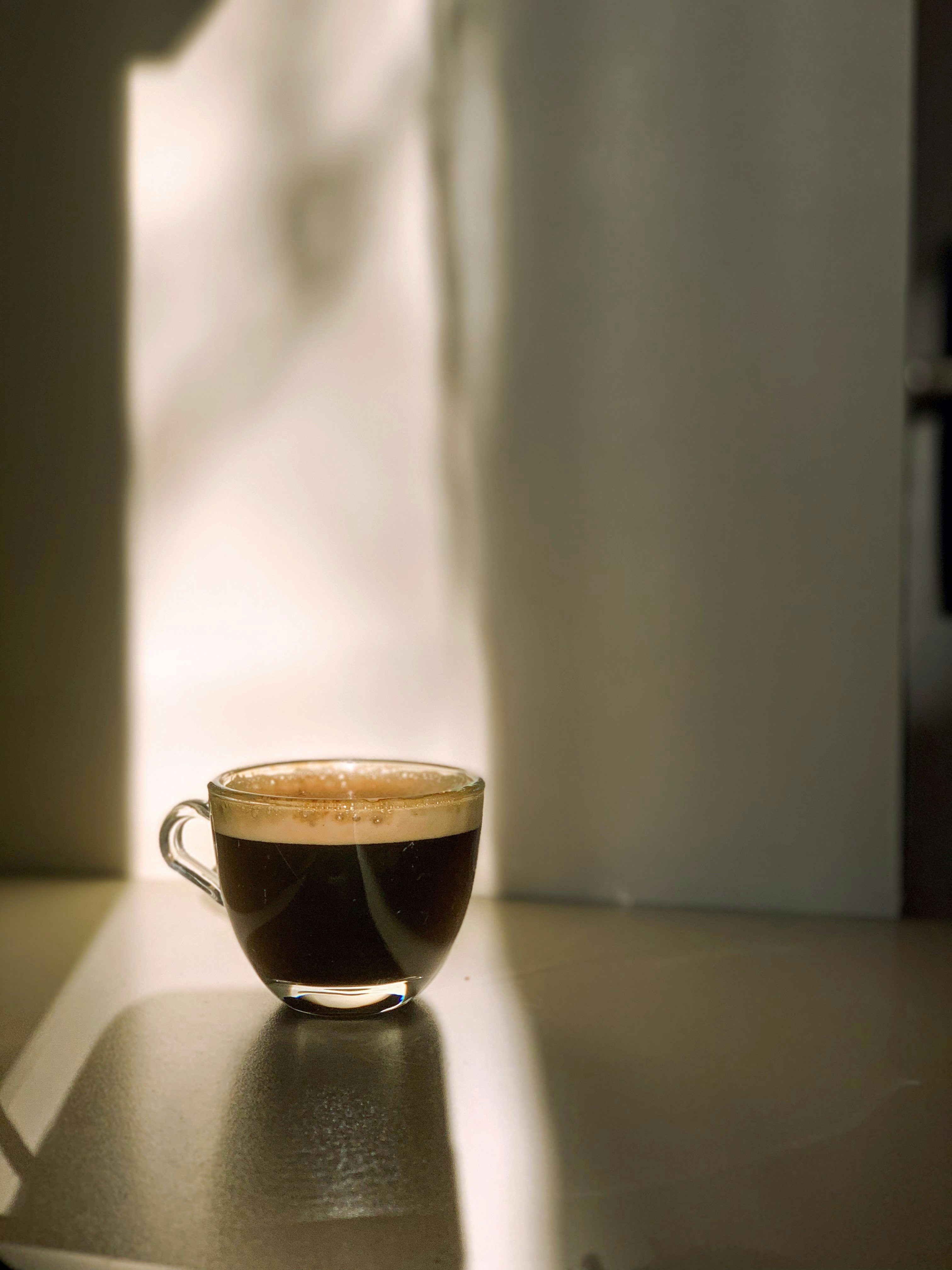 a cup of coffee sitting on top of a table