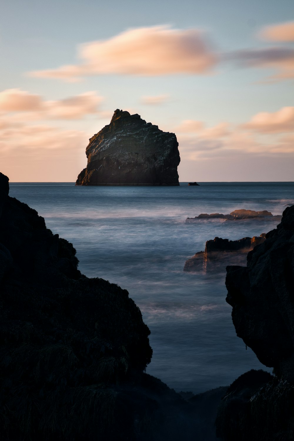 a large rock sticking out of the ocean