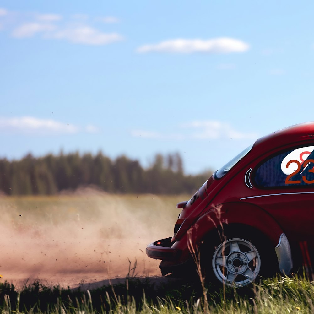 a small red car with an olympic symbol painted on it's side