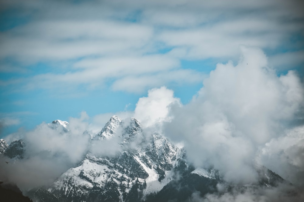 a view of the top of a mountain covered in clouds