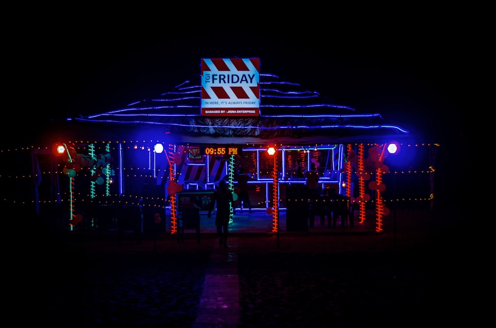 a man standing in front of a building covered in christmas lights