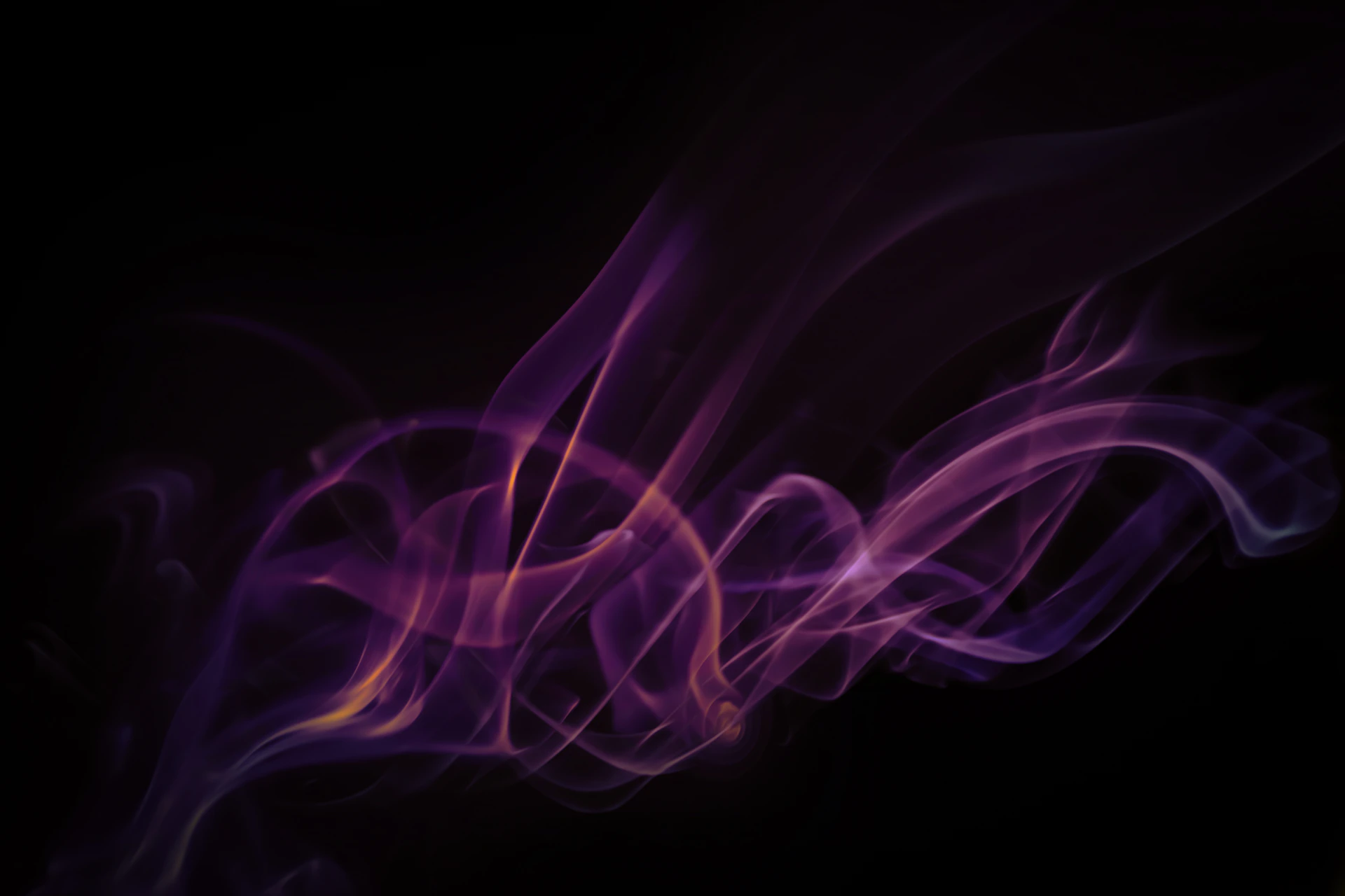 a purple and yellow smoke swirl on a black background