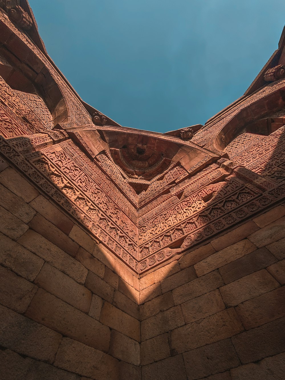 a view of the roof of a building with a blue sky in the background