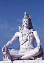 a statue of a person sitting in a lotus position