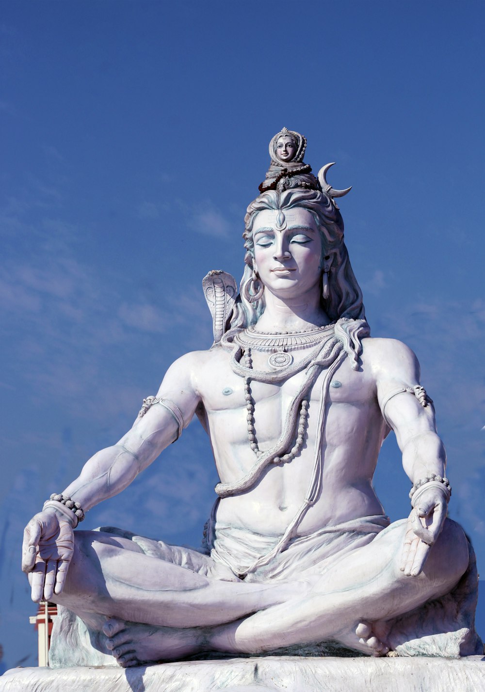 a statue of a person sitting in a lotus position