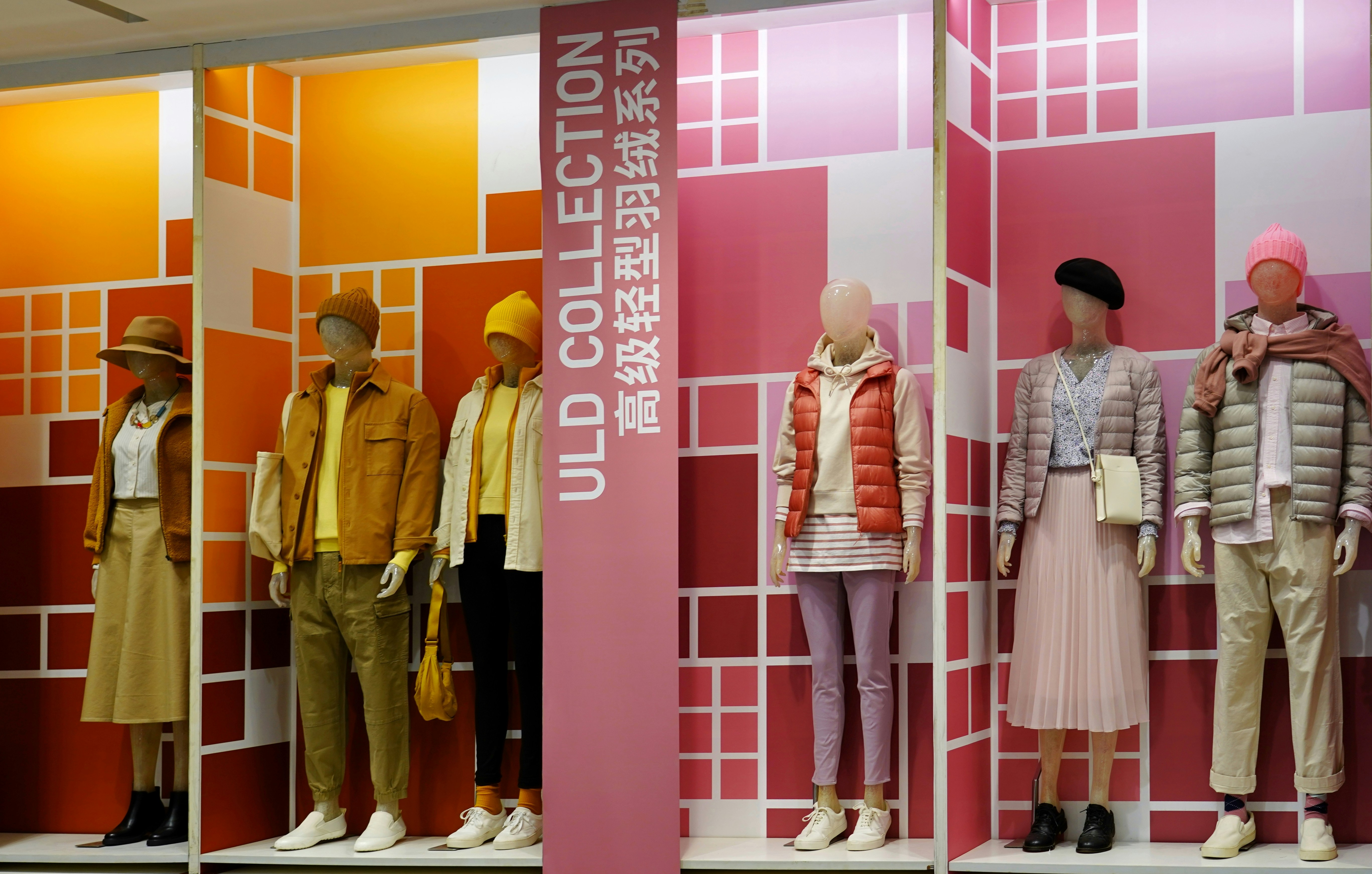 a group of mannequins that are standing in front of a wall