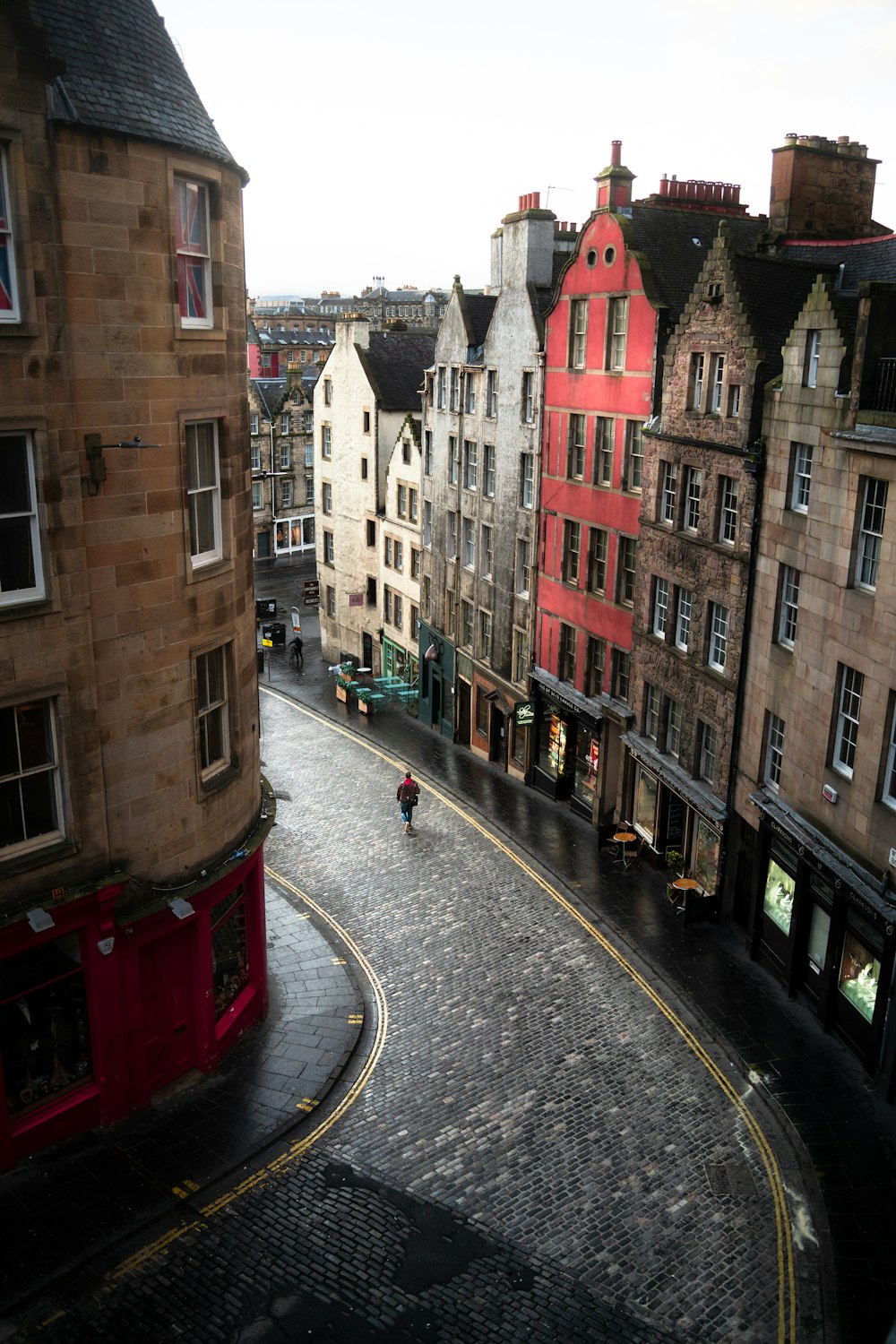 a person riding a bike down a cobblestone street