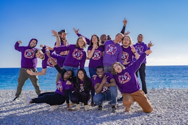 a group of people standing on top of a beach