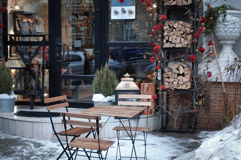 a couple of wooden chairs sitting outside of a store