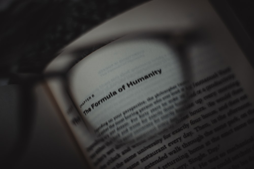 a close up of a book with a magnifying glass