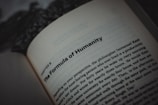 An open book displaying text, with a focus on the title, 'The Formula of Humanity.' The page is part of a chapter, with surrounding text visible in smaller font. The background is blurry, emphasizing the text.