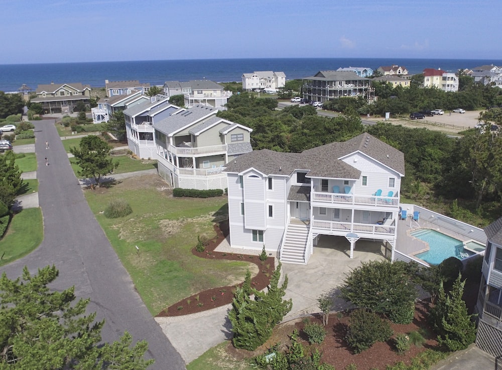 an aerial view of a row of houses near the ocean