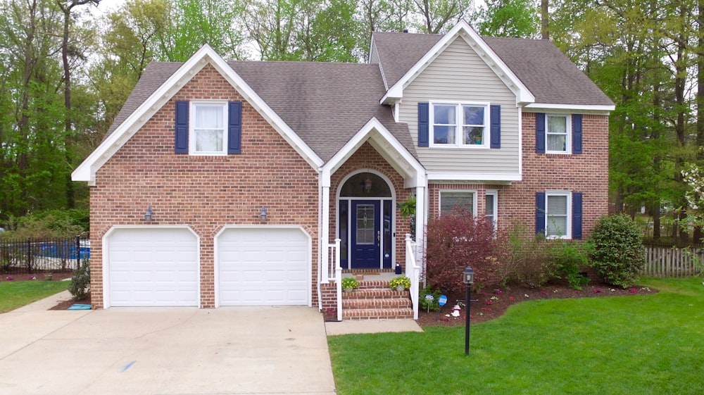 a large brick house with two garages