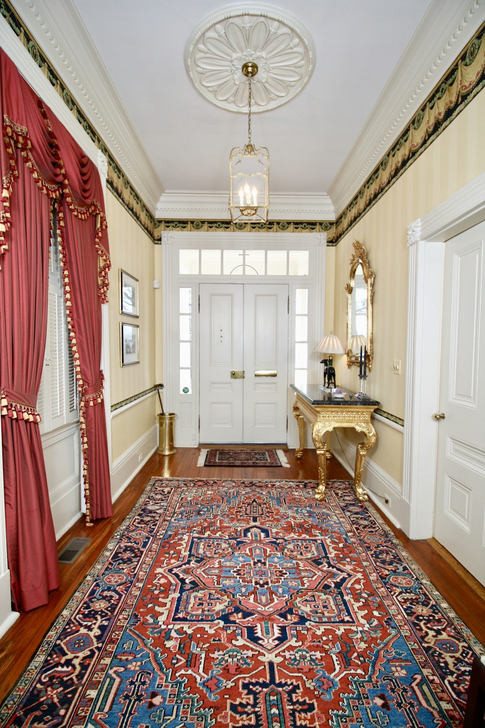 a hallway with a rug and a door