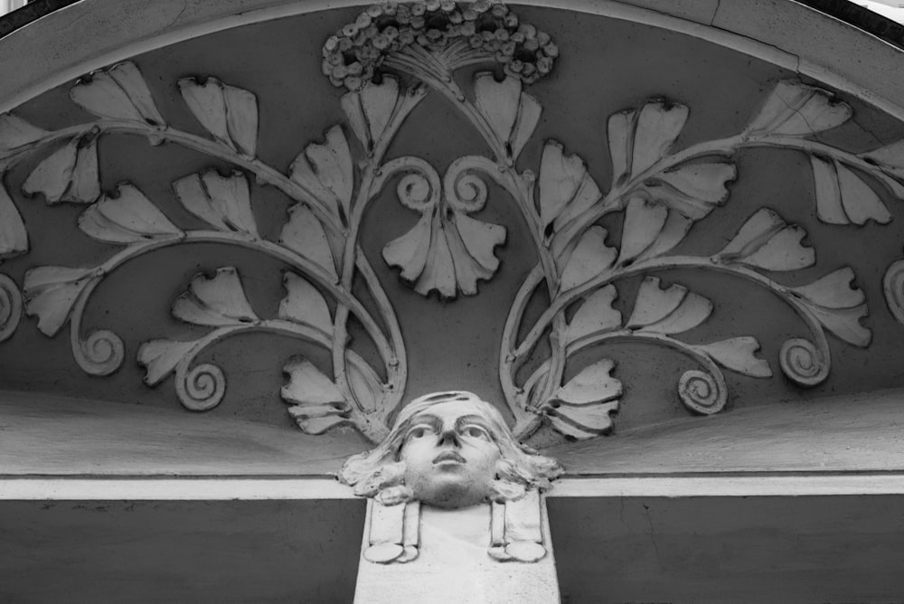 a black and white photo of a face on a building