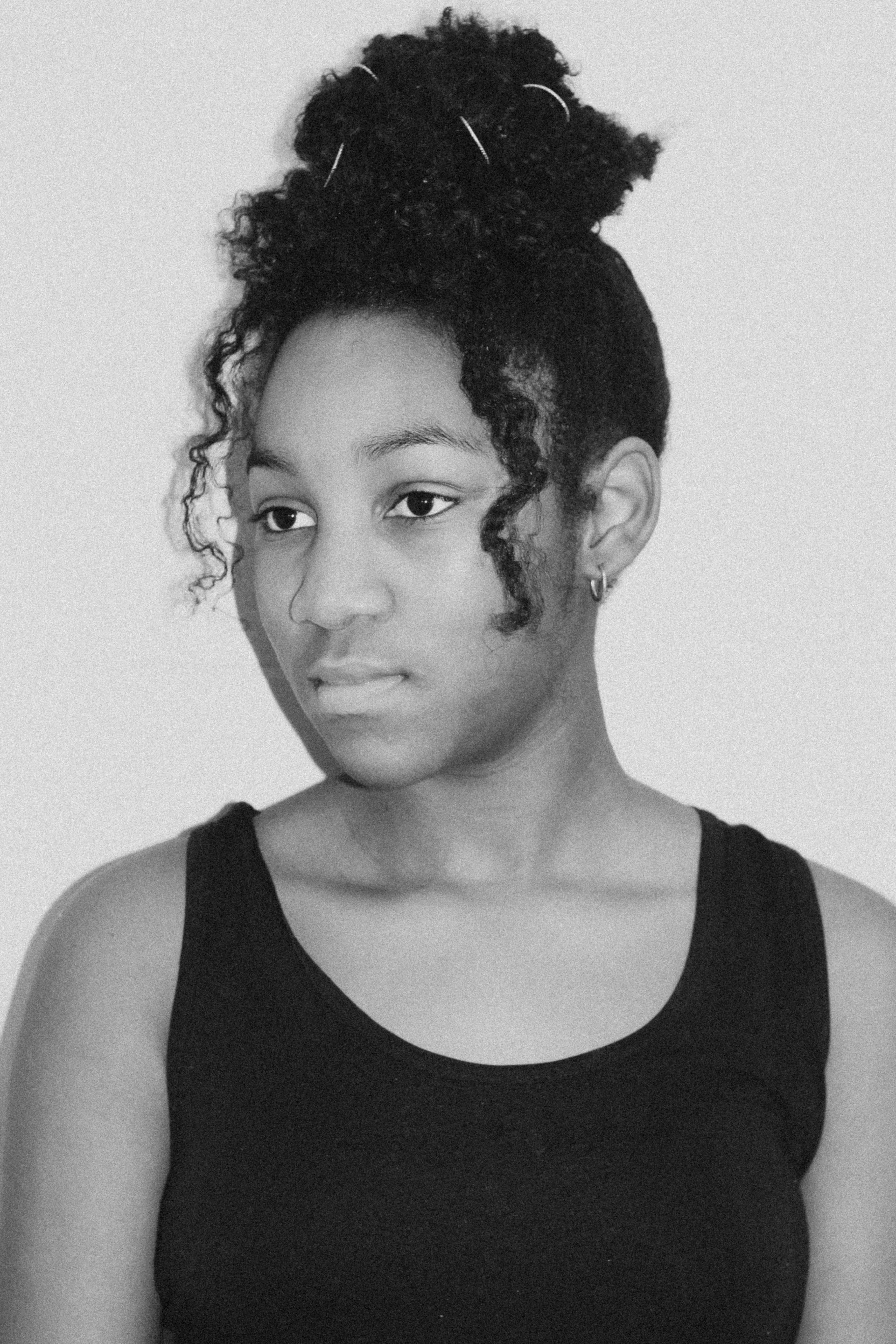 a black and white photo of a woman with curly hair