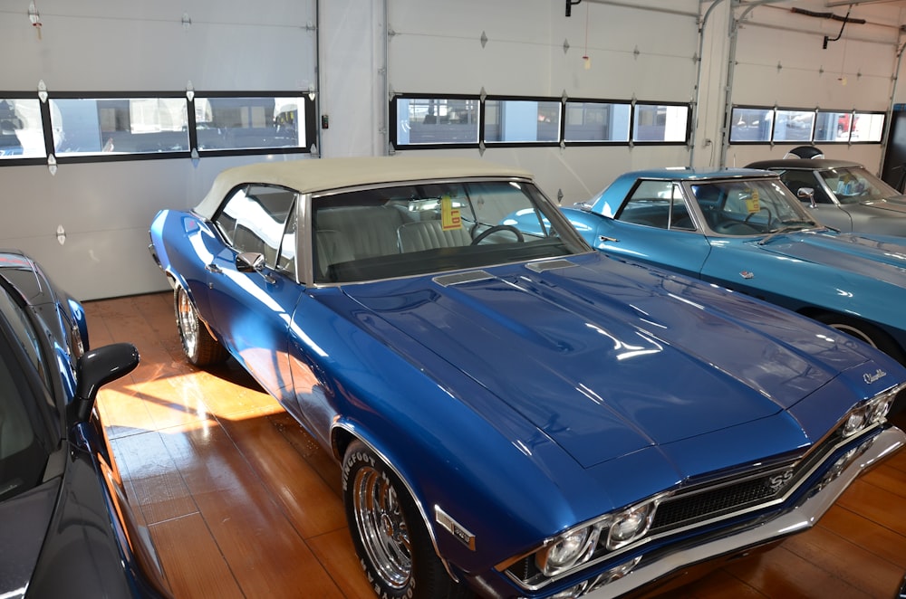 a group of cars parked next to each other on a wooden floor