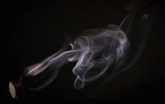 the smoke is blowing in the dark on the clock