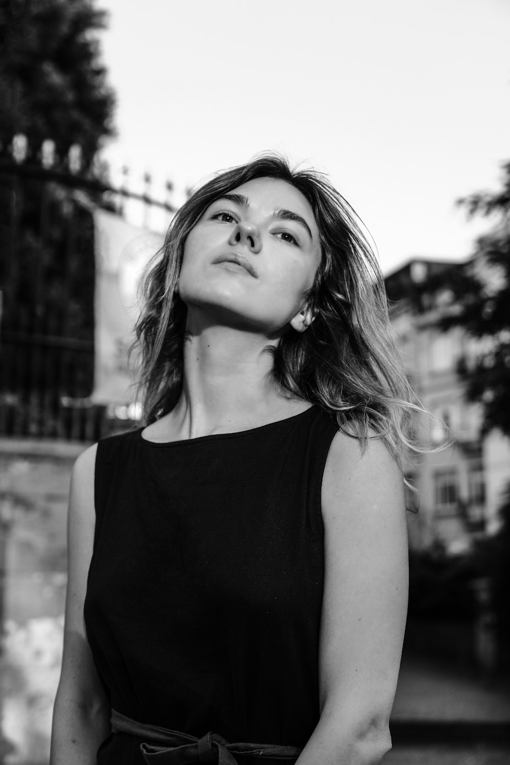 a black and white photo of a woman looking up