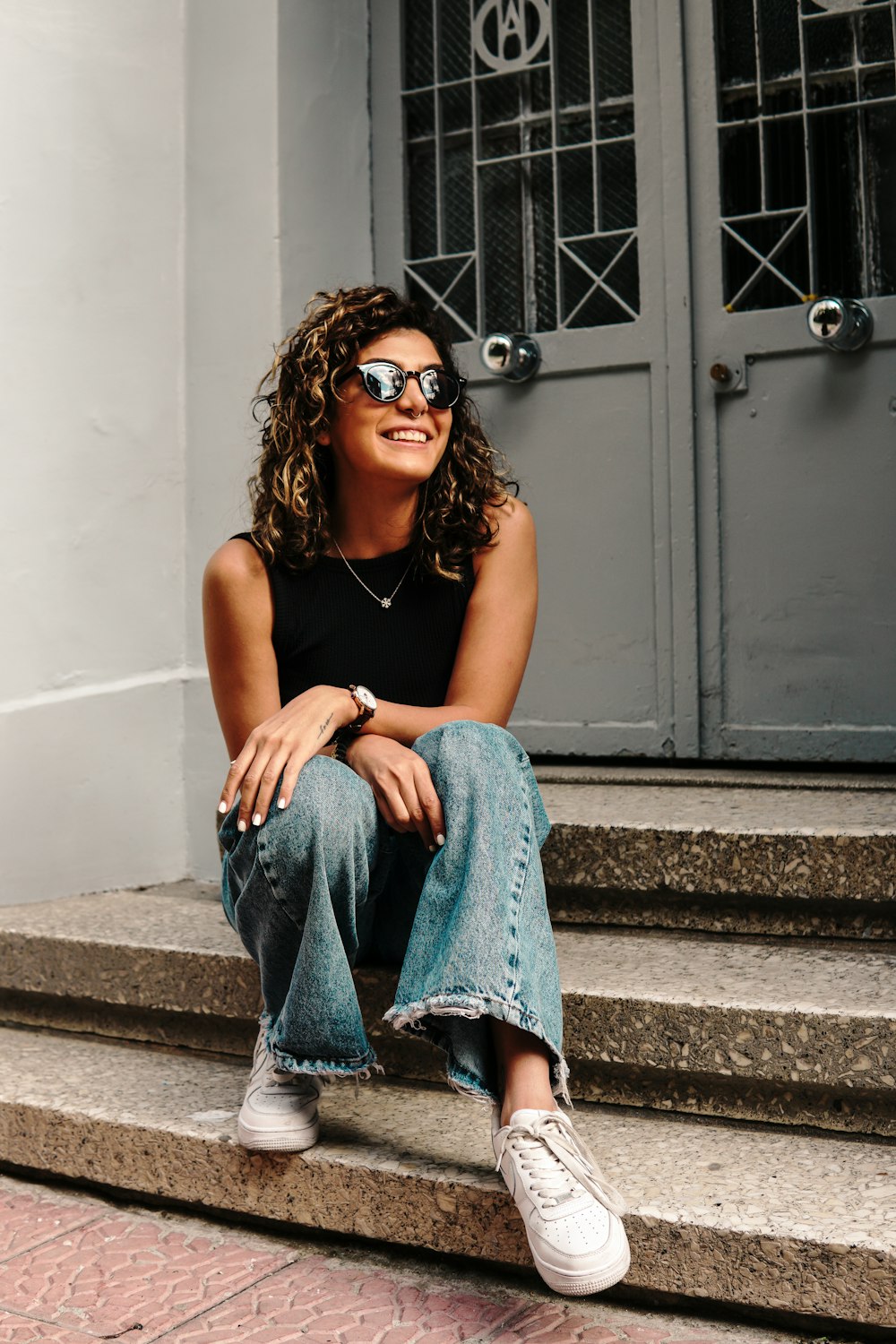 a woman sitting on the steps of a building