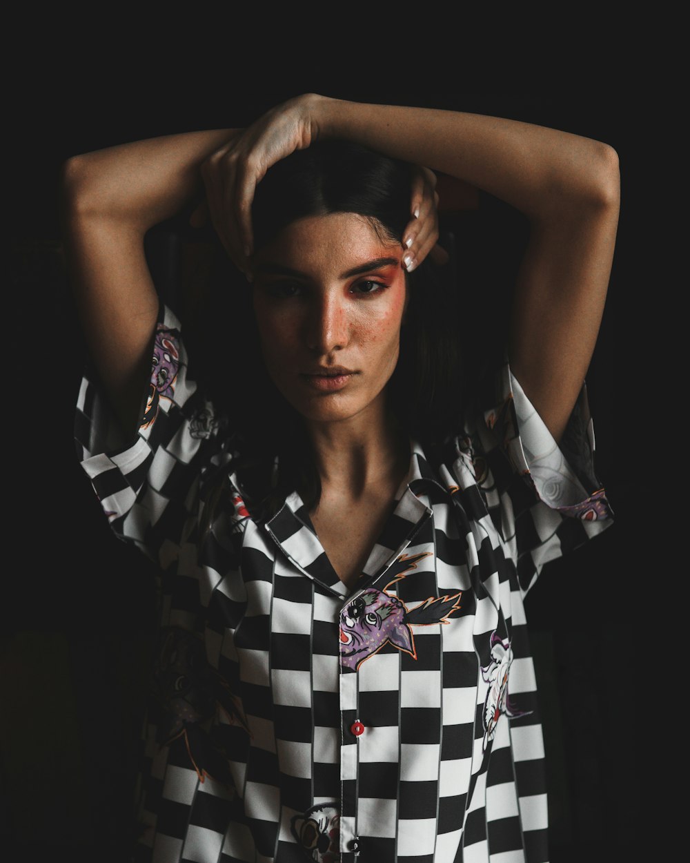 a woman in a black and white checkered shirt