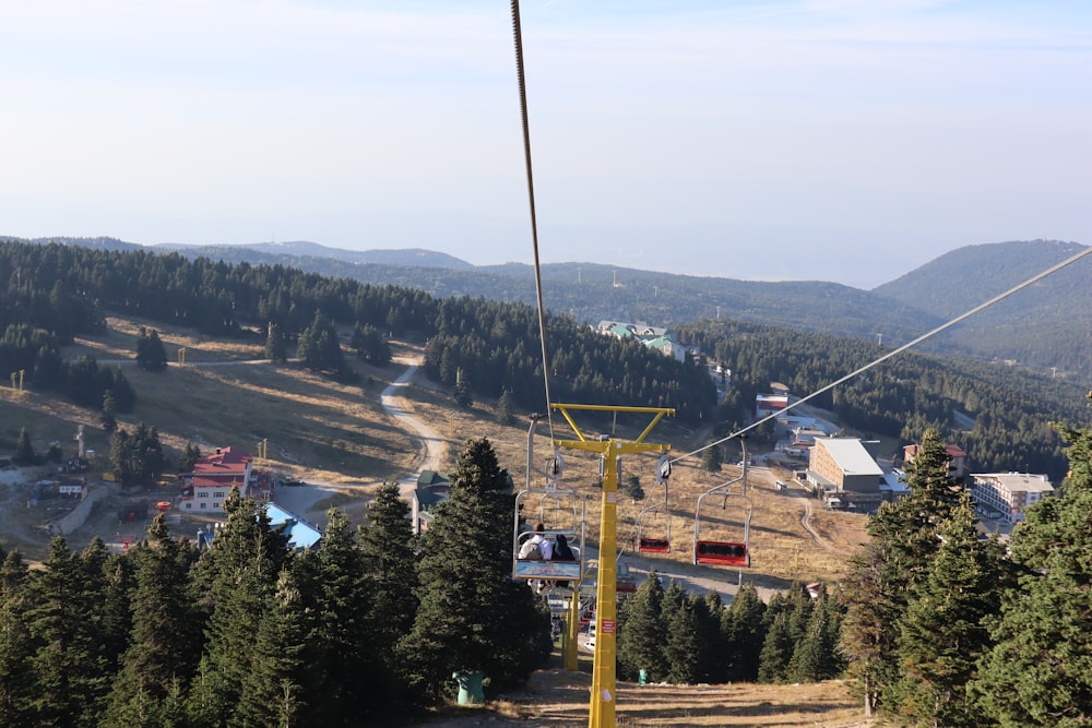 a ski lift going up a hill in the mountains