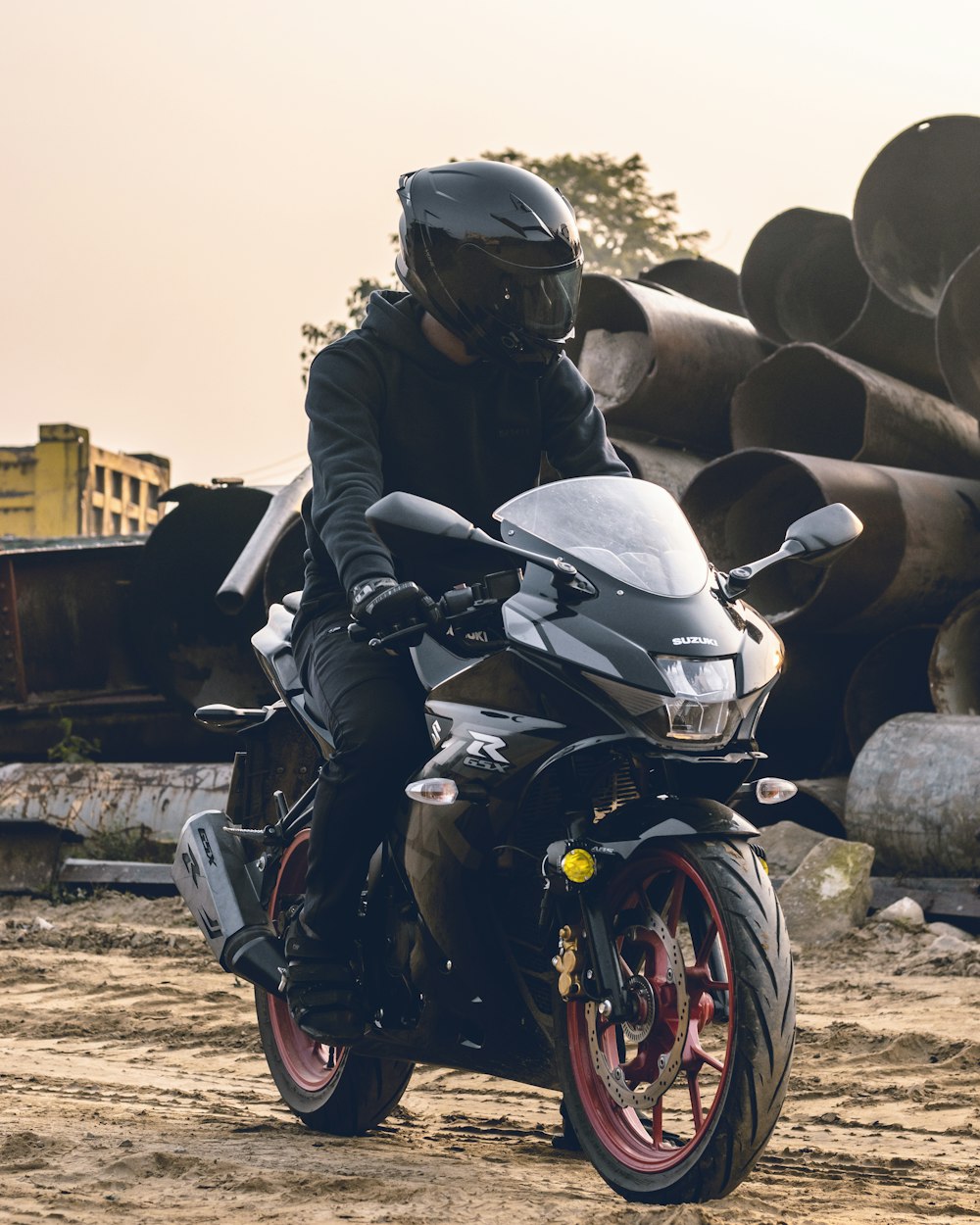 a man riding a motorcycle on top of a dirt field