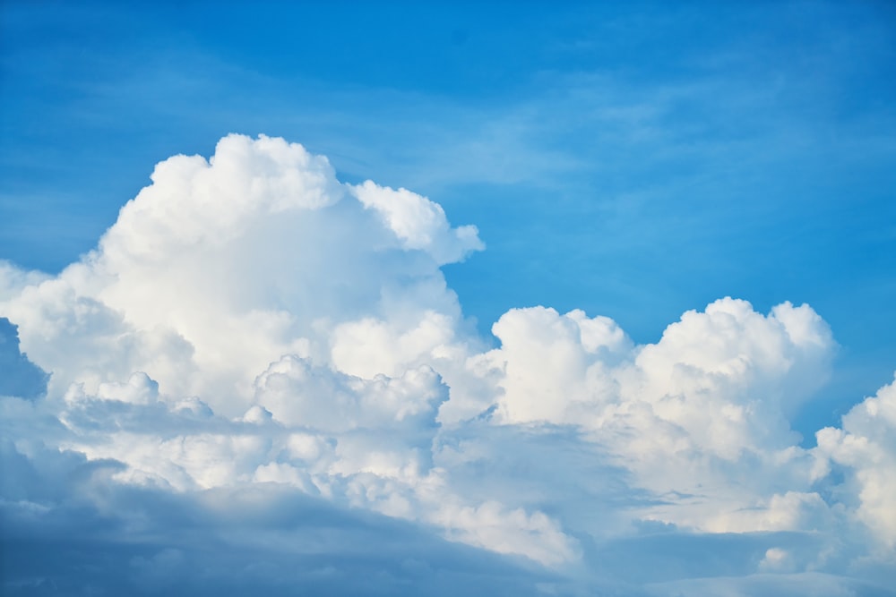 a plane flying in the sky with a lot of clouds